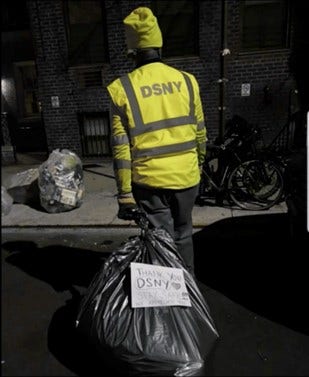 New-York-City-Department-of-Sanitation worker carrying refuse and recyclables