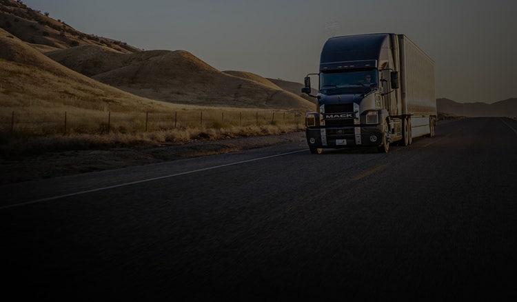 A truck driving down a road Description automatically generated with low confidence