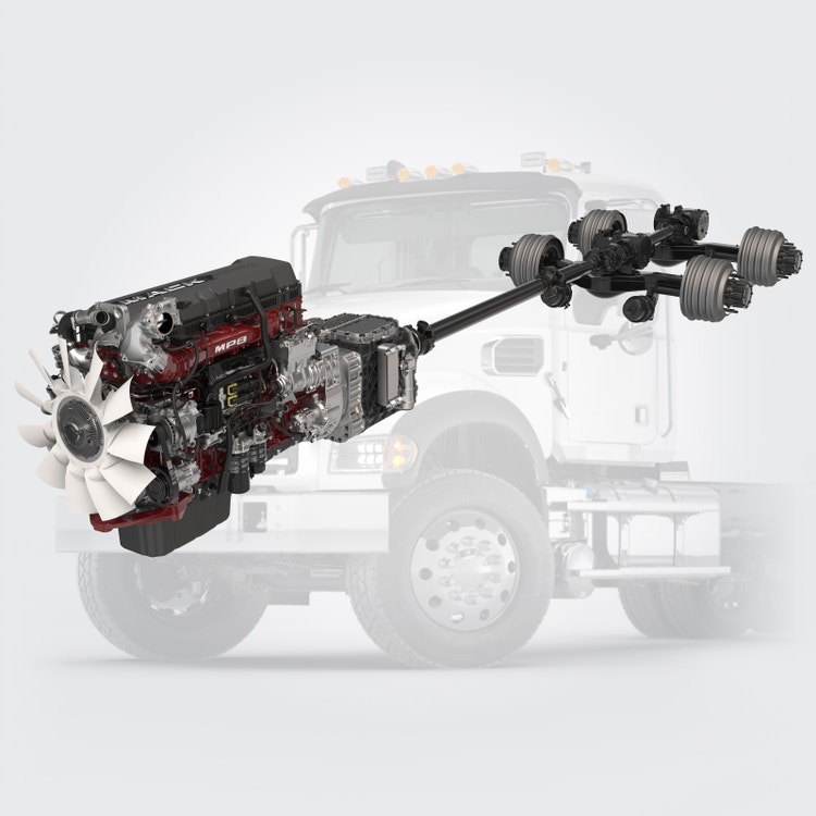Mack MP8 engine and drivetrain assembly displayed in front of a semi-transparent Mack Granite truck.