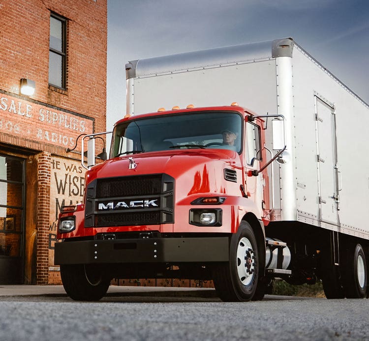 Red Mack MD Series box truck with clear back-of-cab space, pre-wired for body builder connections to Cummins and Allison systems.